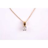 An 18ct yellow gold and solitaire diamond pendant, set with a round brilliant-cut stone of