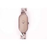 Asprey. A lady's silver wristwatch, the elongated oval brushed silvered dial with simple arrowhead