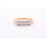 An 18ct yellow gold and diamond ring, set with three rows of round brilliant-cut diamonds, the