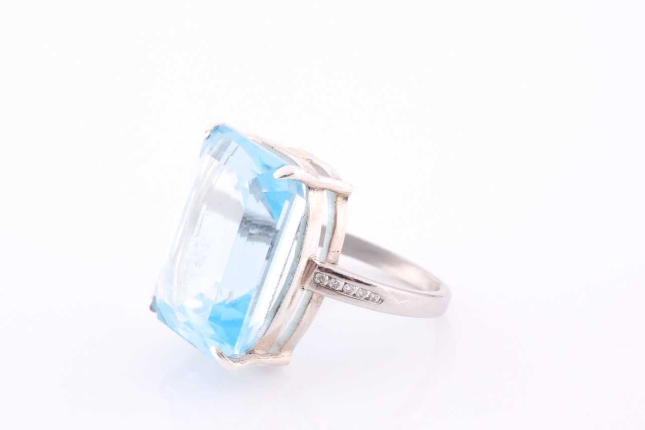 A platinum, blue topaz and diamond dress ring, set with a mixed rectangular-cut topaz, of - Image 3 of 4