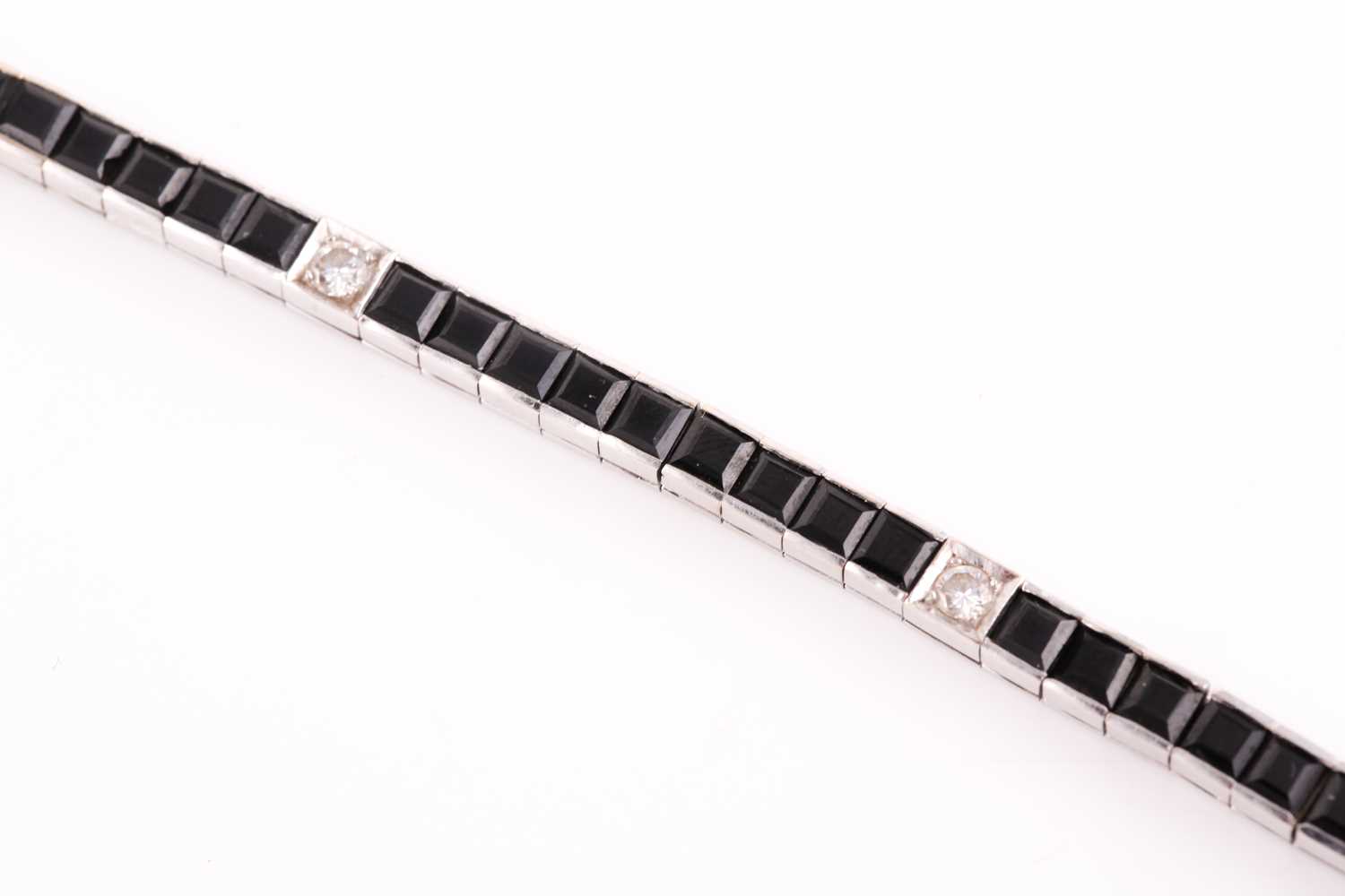 An 18ct white gold, diamond, and onyx line bracelet, the segments set with square-cut black onyx, - Image 2 of 6