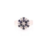 An 18ct white gold, diamond, and sapphire cluster ring, set with a cluster of round-cut sapphires