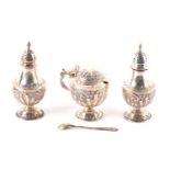 A late Victorian three-piece silver cruet set, London 1901 by Mappin Brothers, with embossed