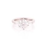 A platinum and diamond ring, set with a round brilliant-cut diamond of approximately 1.50 carats,