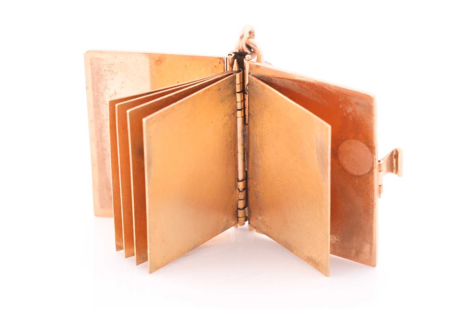 A yellow gold pendant in the form of a book, the hinged cover with quatrefoil decoration, opening to - Image 2 of 4