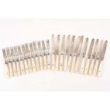 An early 20th century set for twelve silver fruit knives and forks London 1928 by the gold and