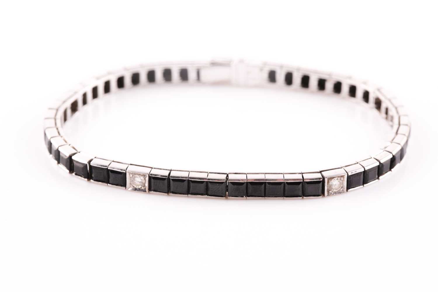 An 18ct white gold, diamond, and onyx line bracelet, the segments set with square-cut black onyx,