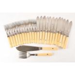 An early 20th century set for twelve fish knives and forks and a pair of scimitar bladed fish