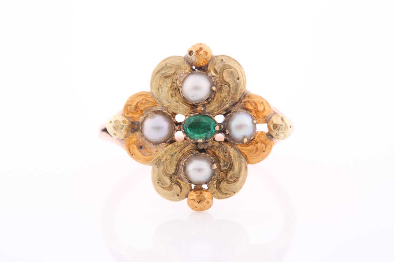 A 19th century yellow metal, emerald, and pearl ring, the quatrefoil mount with lightly engraved