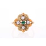 A 19th century yellow metal, emerald, and pearl ring, the quatrefoil mount with lightly engraved