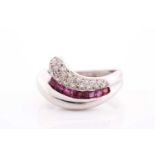 An 18ct white gold, diamond, and ruby ring, of swept design, pave-set with round brilliant-cut