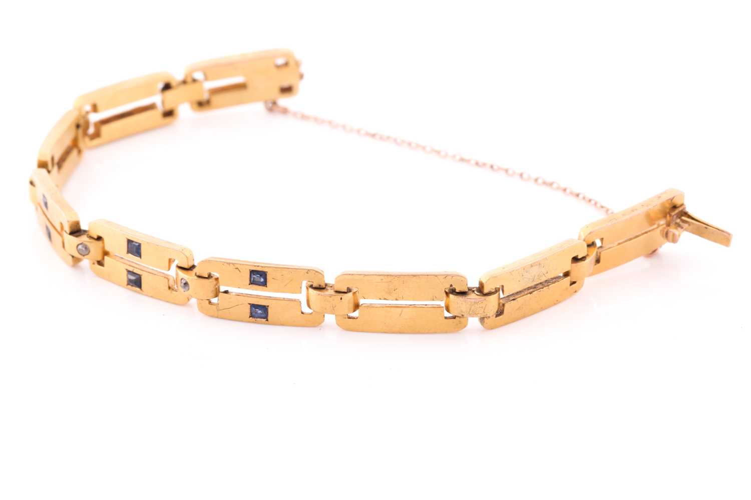 A yellow metal, diamond and sapphire bracelet, comprised of articulated bar links, the three - Image 2 of 4