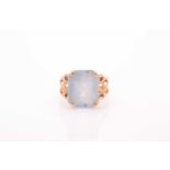 A single stone aquamarine dress ring, the rectangular mixed cut aquamarine in four claw mount to a