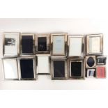 A large collection of silver and white metal mounted photograph frames, the largest aperture size