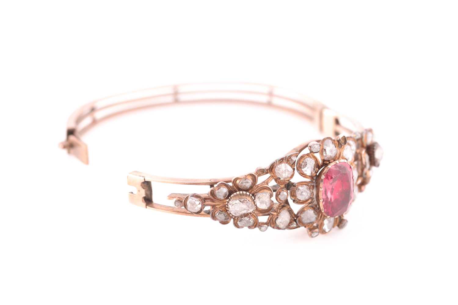 An antique yellow metal and diamond bangle, set with a reddish pink central stone, likely spinel, - Image 5 of 6