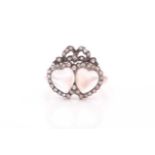An antique diamond and moonstone double heart ring, the mount set with heart-shaped cabochon