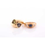 An 18ct yellow gold gypsy ring, set with a cabochon sapphire and two small diamonds, size M,