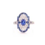 A platinum, diamond, and sapphire plaque ring, in the Art Deco style, centred with a mixed oval-