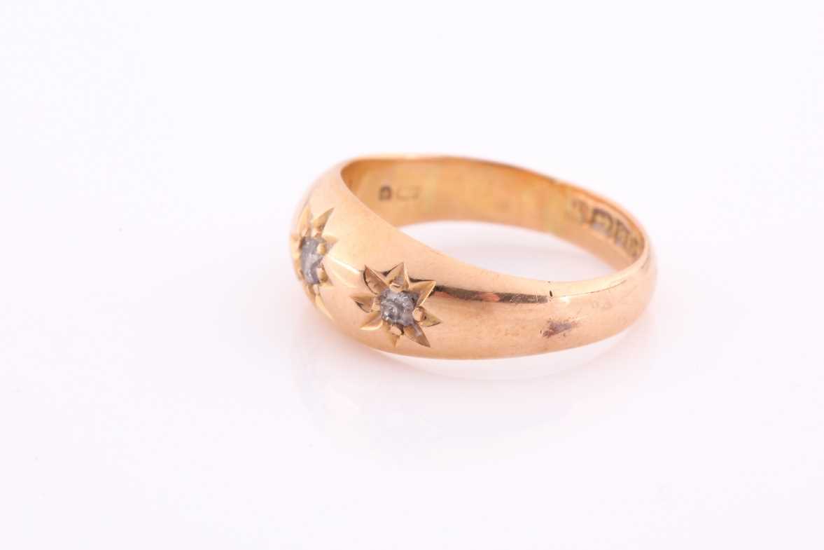 A three stone gypsy set ring, the graduated old brilliant cut diamonds in tapering 18 carat rose - Image 3 of 5