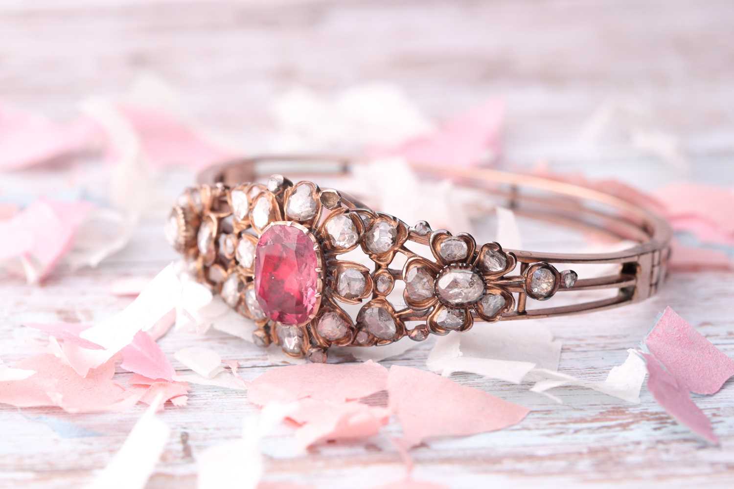 An antique yellow metal and diamond bangle, set with a reddish pink central stone, likely spinel, - Image 6 of 6