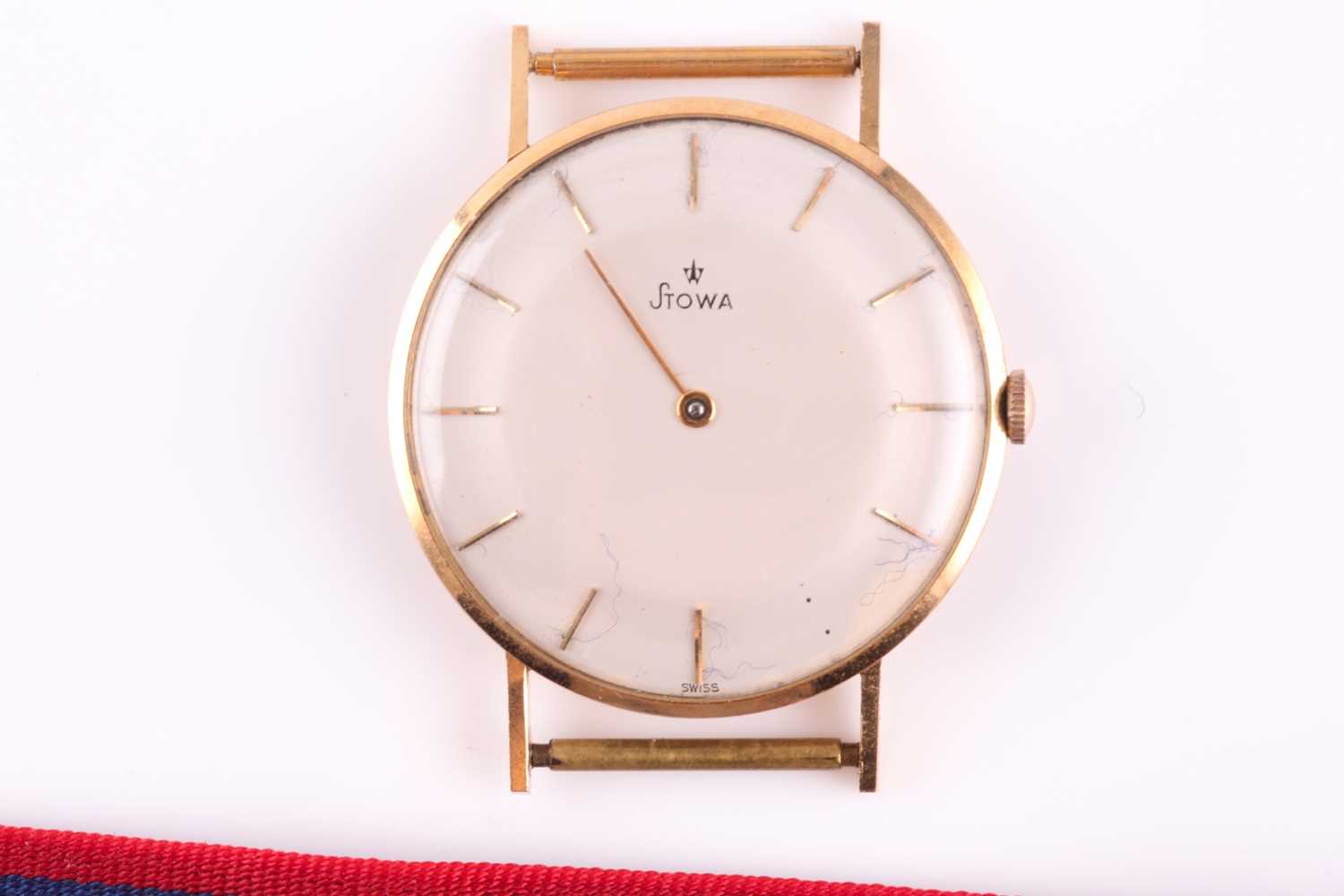 A yellow metal Stowa watch, the plain cream dial with gilt batons (one lacking), case 3.4 cm