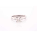 A platinum and diamond ring, set with a princess-cut diamond of approximately 0.80 carats,