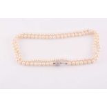 An opera length cultured pearl necklace, fastened with an 18ct white gold ball and clip clasp,