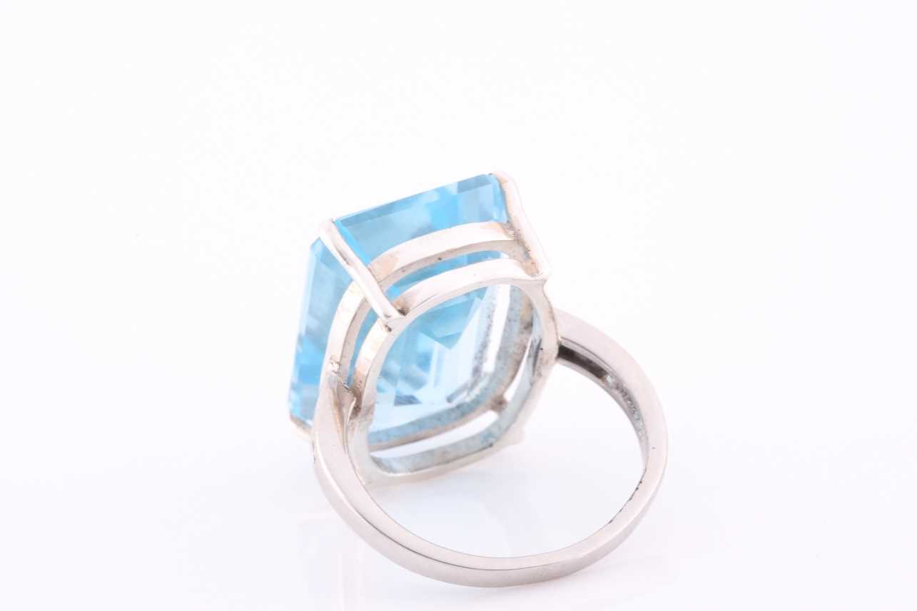 A platinum, blue topaz and diamond dress ring, set with a mixed rectangular-cut topaz, of - Image 4 of 4