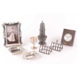 A mixed group of silver items, comprising two small toast racks, a miniature covered tureen by