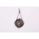 A 19th century white metal and paste pendant, centered with a cushion-cut paste pendant, the