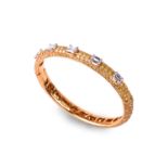 Graff. An 18ct yellow gold and diamond bangle, set with five brilliant baguette-cut diamonds of