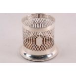 A silver bottle holder. London 1908 by Mappin and Webb. Cylindrical with pierced sides and turned