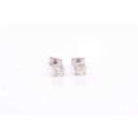 A pair of platinum and diamond earrings, the round brilliant-cut diamonds of approximately 0.67