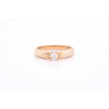An 18ct yellow gold and diamond ring, claw-set with a round brilliant-cut diamond of approximately