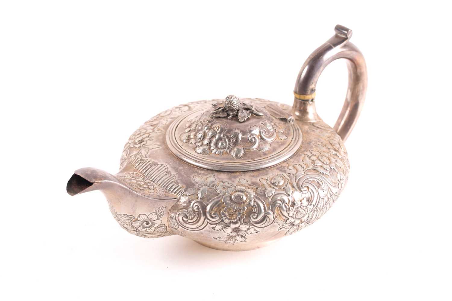 A William IV silver teapot, London 1830 by Joseph Angell, of squat form with repoussé foliate