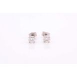 A pair of platinum and diamond earrings, the round brilliant-cut diamonds of approximately 0.56