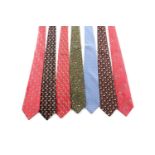 A group of seven Ferrogamo silk ties, various designs, in blue, red, green, and black silk. (7)