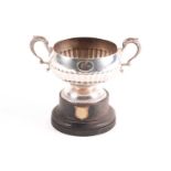 A small silver trophy cup; London 1912 by The Goldsmiths and Silversmiths Company. Circular, part