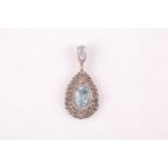 A diamond and aquamarine pendant, set with a claw-mounted mixed oval-cut aquamarine, within a