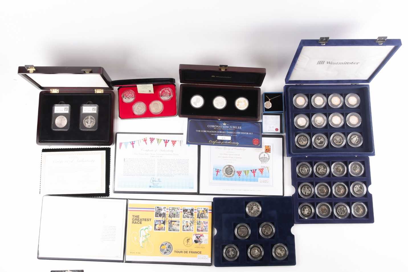 Seven boxed commemorative coin sets, comprising: 1953 Coronation Sixpence in gold-plated diamond