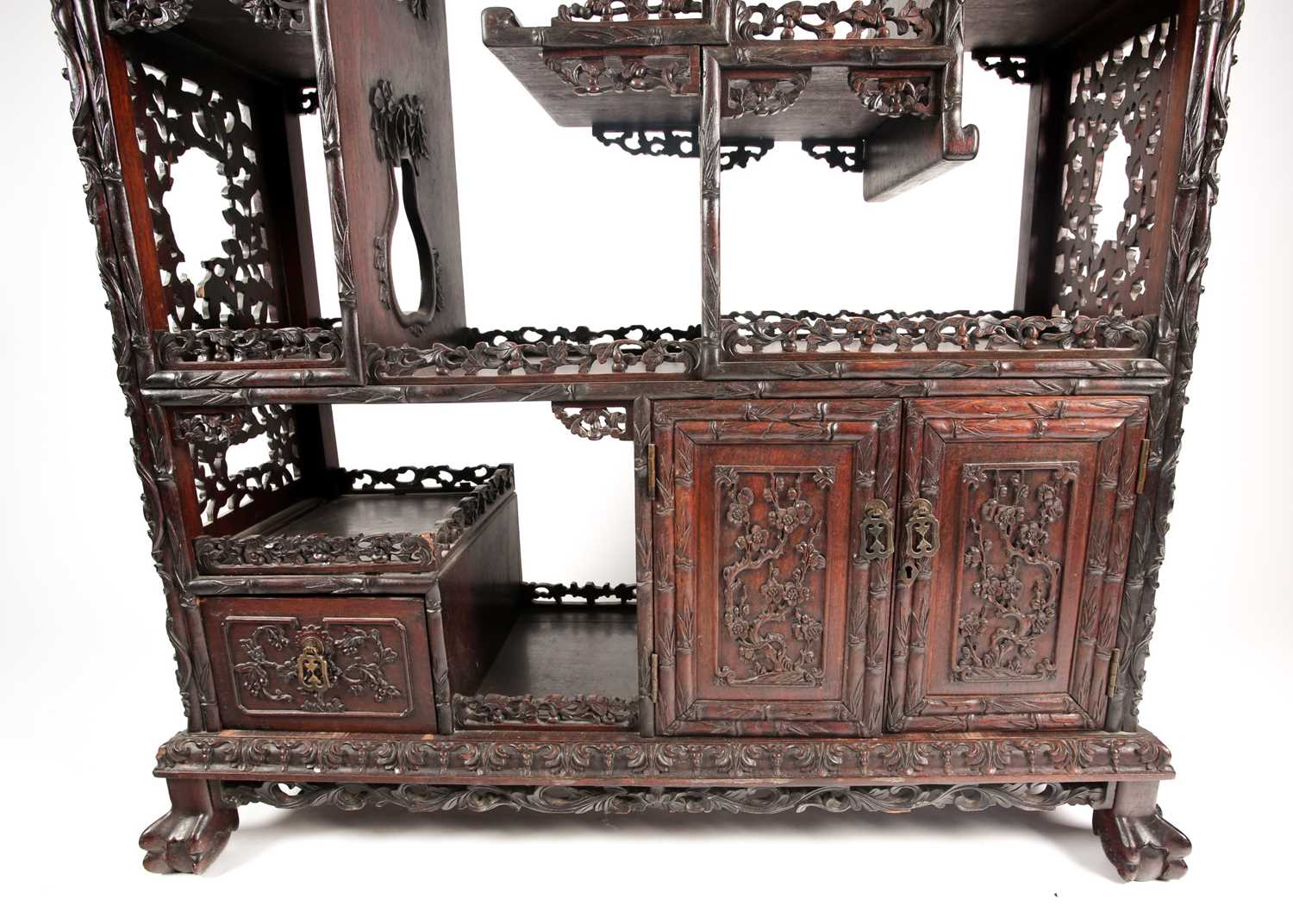 A Chinese hongmu open cabinet, early 20th century, carved throughout with Dogs of Fo, fruiting - Image 3 of 22