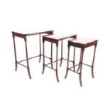 A nest of three cartouch topped mahogany inner sliding occasional tables. Each table with inset