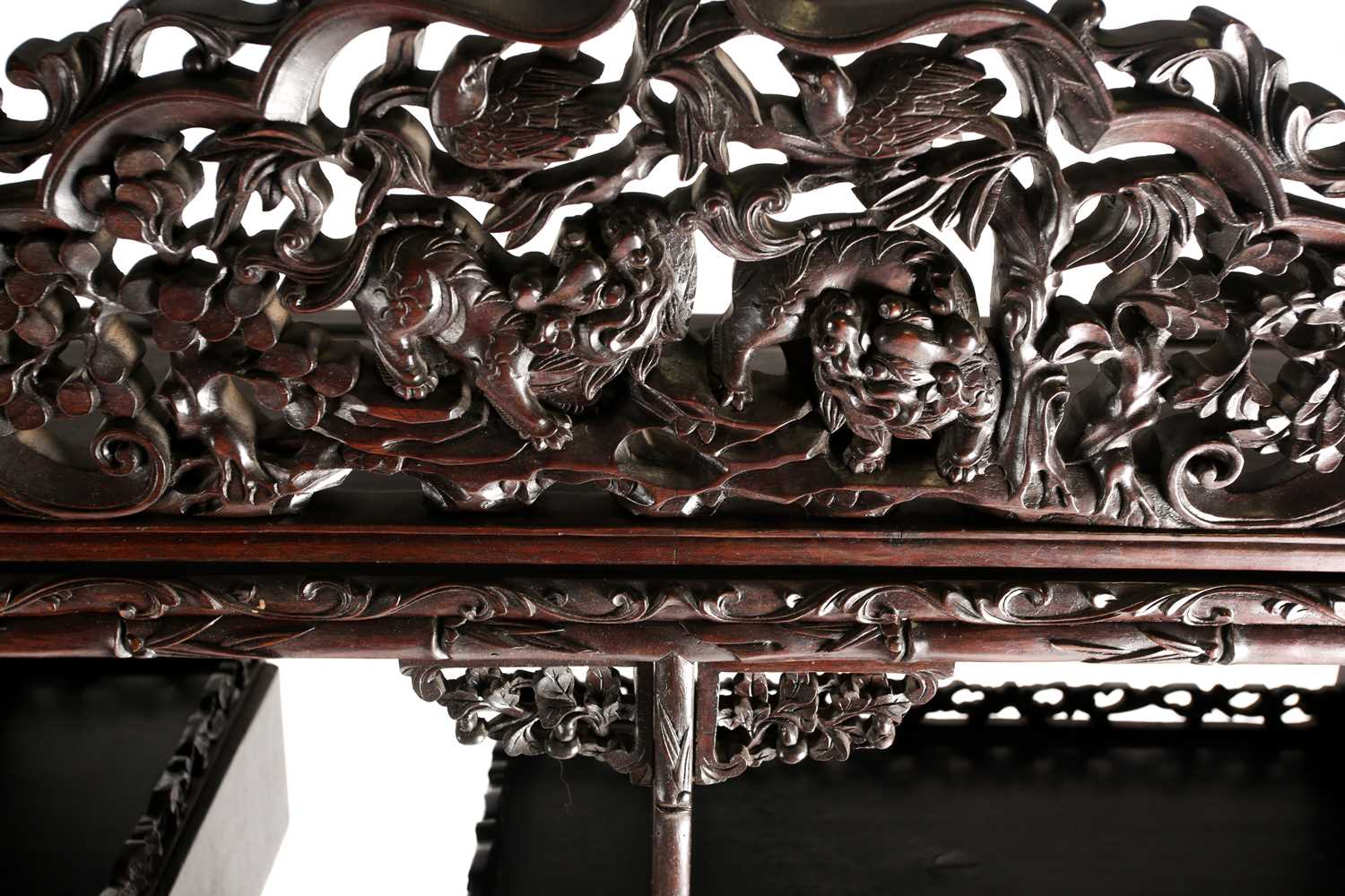 A Chinese hongmu open cabinet, early 20th century, carved throughout with Dogs of Fo, fruiting - Image 4 of 22