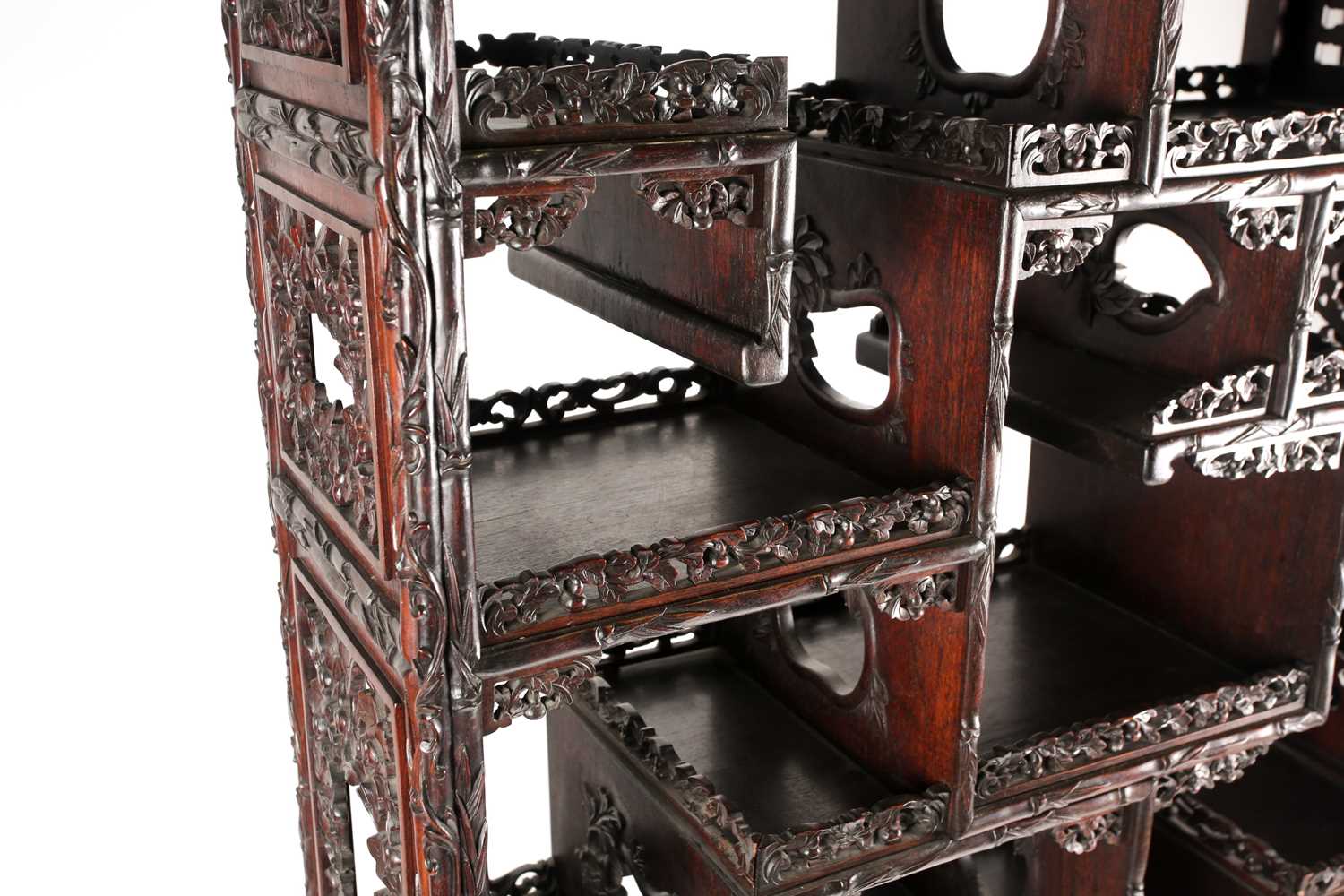 A Chinese hongmu open cabinet, early 20th century, carved throughout with Dogs of Fo, fruiting - Image 6 of 22