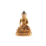 A Chinese gilt bronze buddha, Qing, seated in bhumisparsha mudra, on a double lotus throne, 4007g,