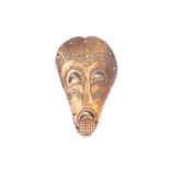 A Luba animal bone socket witch doctors mask, Democratic Republic of Congo, the face with