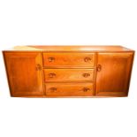 An Ercol golden dawn light elm sideboard with a central bank of drawers flanked by a pair of
