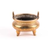 A Chinese polished bronze censer, circa 1900, with twin lug handles above the swollen body decorated