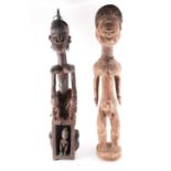 An Ibibio standing male figure, Nigeria, with linear coiffure, the face, neck and shoulders with