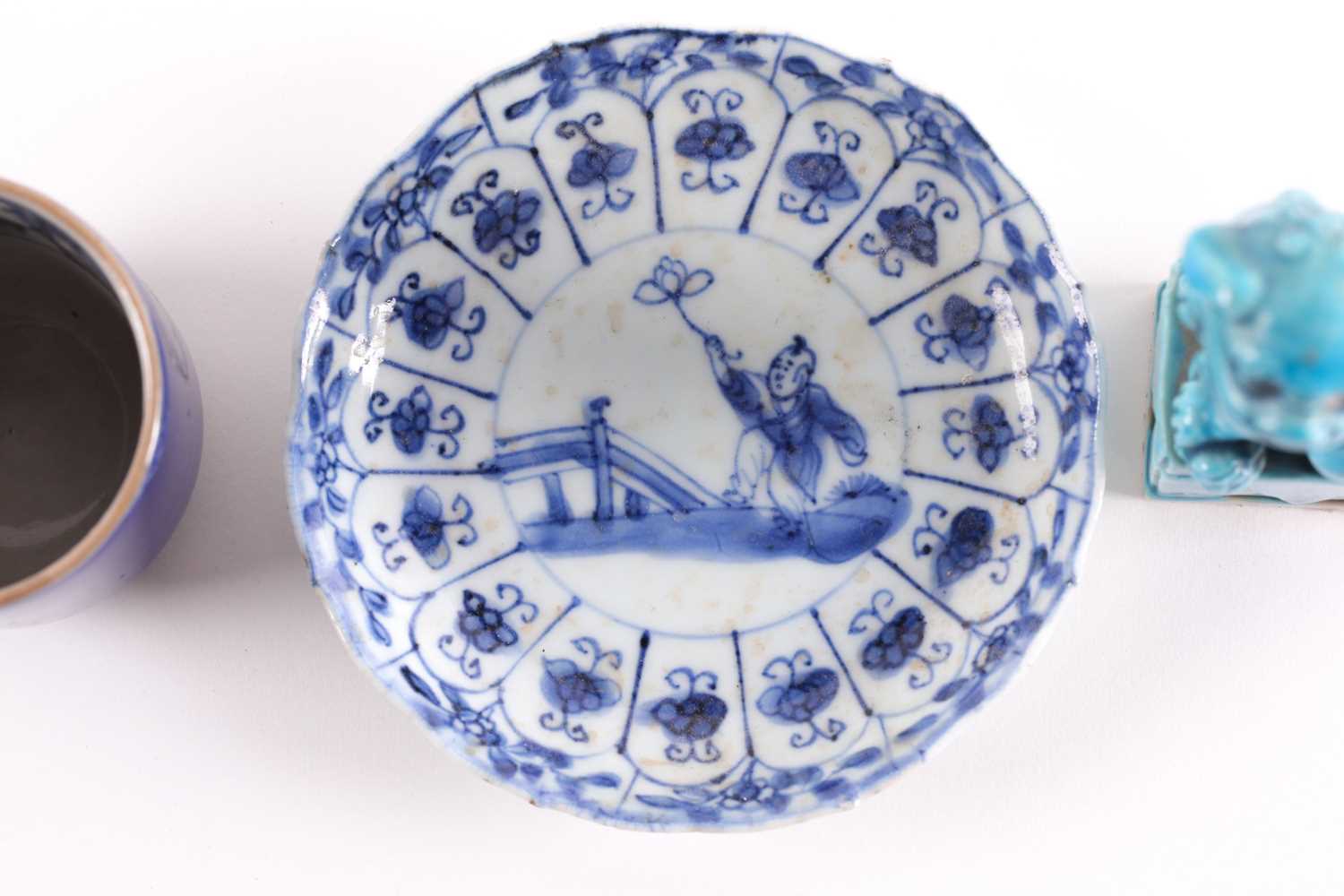 A Chinese blue & white saucer, Kangxi, early 18th century, painted with a boy holding aloft a - Image 6 of 16